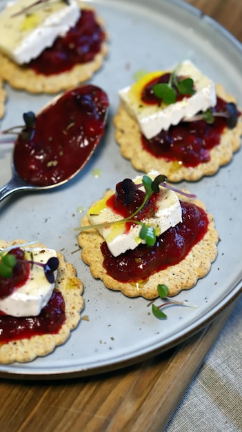 Canapes with brie cheese and berry jam Healthy snack French style