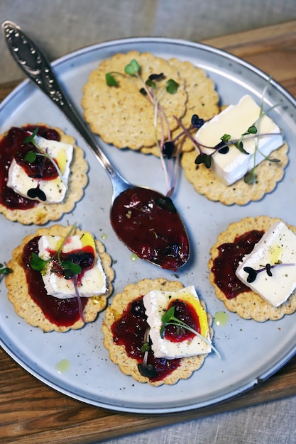 Canapes with brie cheese and berry jam Healthy snack French style