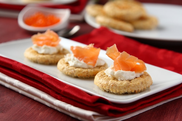 Canapes with oat bran cookies, smoked salmon and cream cheese