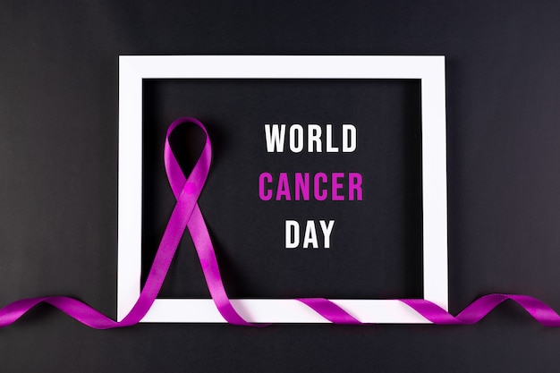 Cancer awareness violet ribbon wrapped white photo frames. World Cancer day.