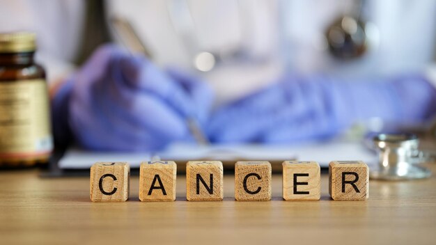 Cancer disease and oncology doctor writes cancer diagnosis and treatment concept of malignant