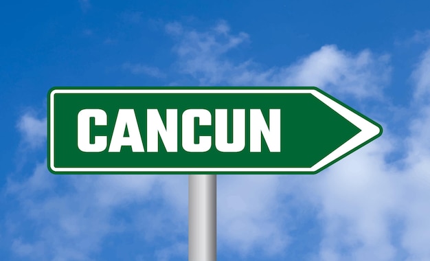 Cancun road sign on cloudy sky background