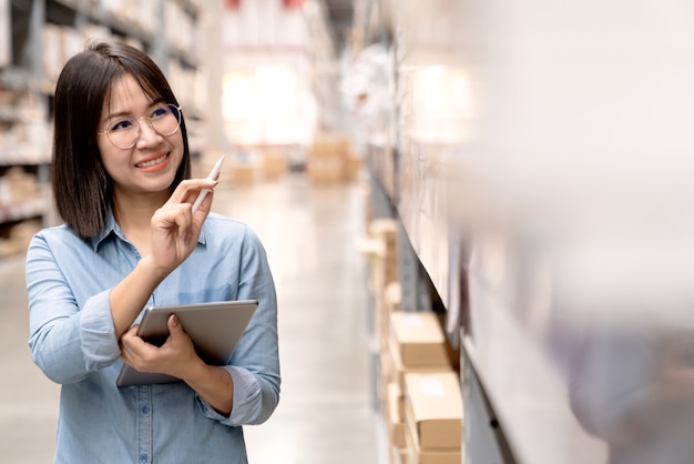 Candid attractive asian employee or staff working in store inventory