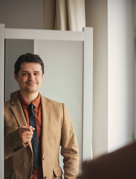 Candid view on young man dressing up 