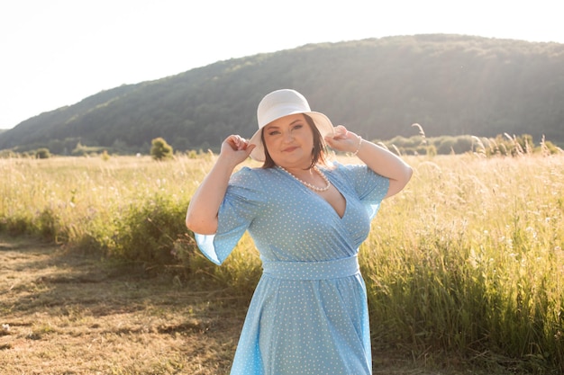 Candid woman in hat at farmland enjoy the summer