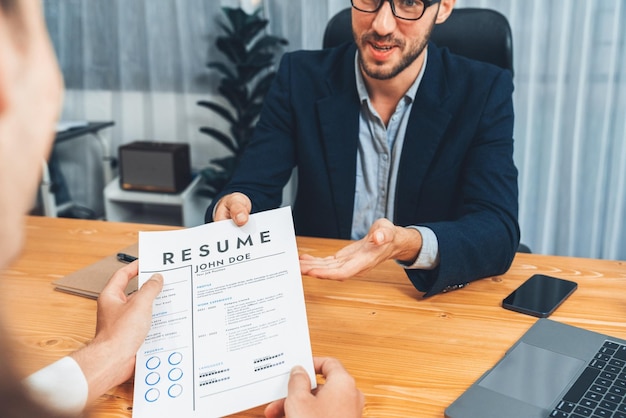 Photo candidate handing resume or cv over table to interviewer entity