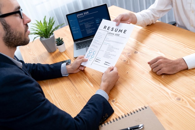 Photo candidate handing resume or cv over table to interviewer entity