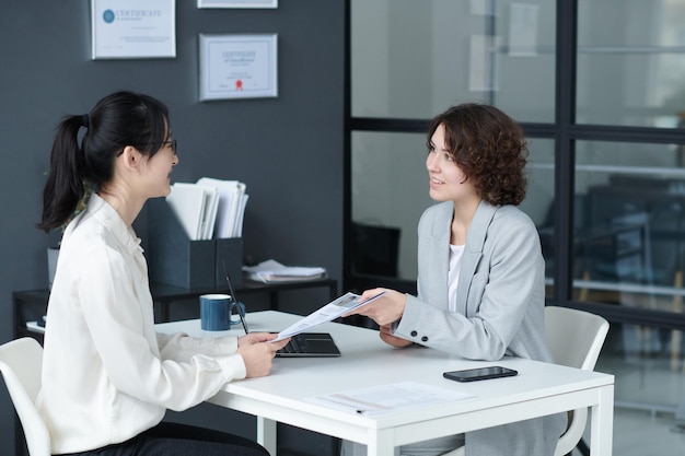 Candidate showing her resume to manager