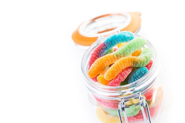 Candies in candy jar on a white background.