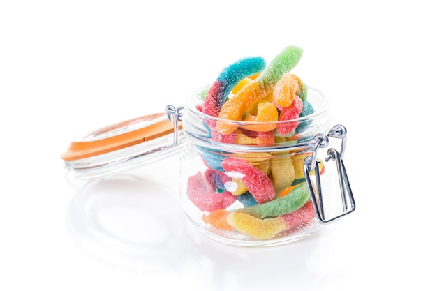 Candies in candy jar on a white background.