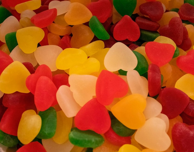 Candies from a vein in the form of multicolored hearts sweets with jelly and sugar colorful array