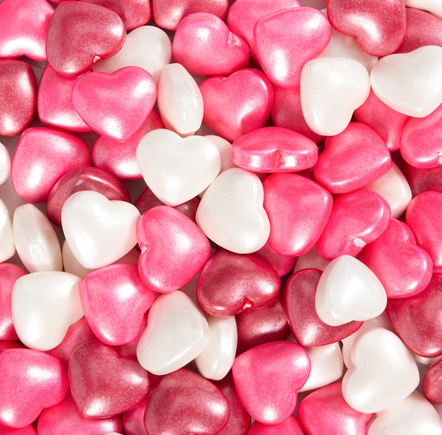 Candies in heart shape as background Valentine's Day