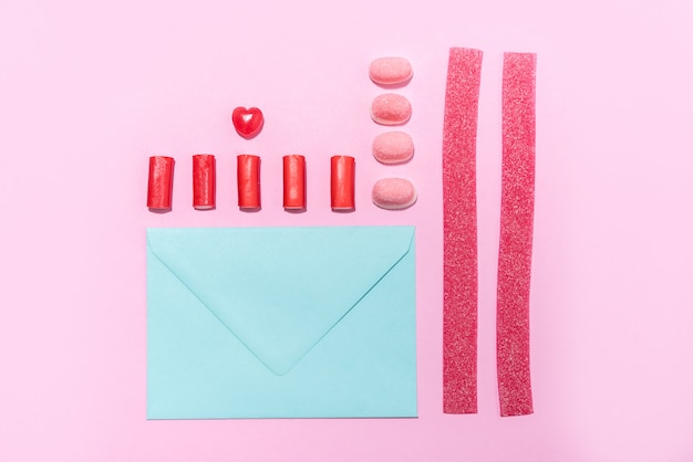 Candies and lollies in a row with blank paper envelope