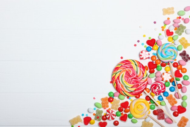 Candies and sweets on a colored background top view with place for text