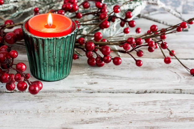 Candle and branch on wooden table