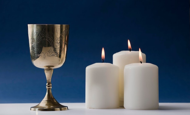 A candle and a chalice with the word holy on it