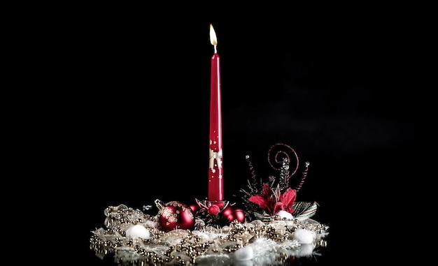 Candle and Christmas composition on a black background