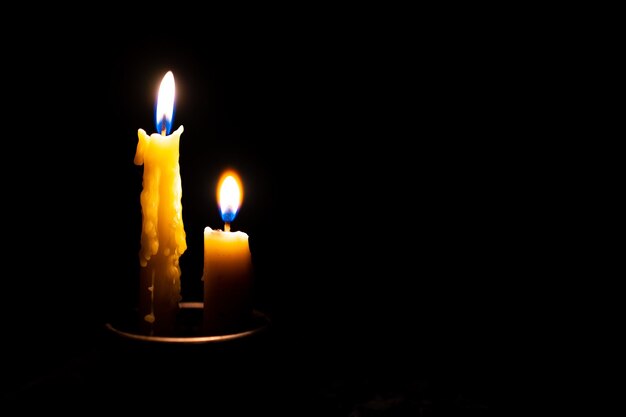 Photo candle in the dark black background