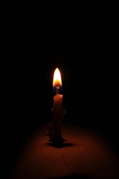 Photo candle drawn in front of a black background