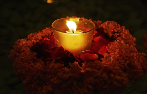 A candle in a flower arrangement