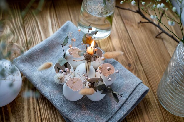 A candle holder with a candle on it and a glass of water on the side.