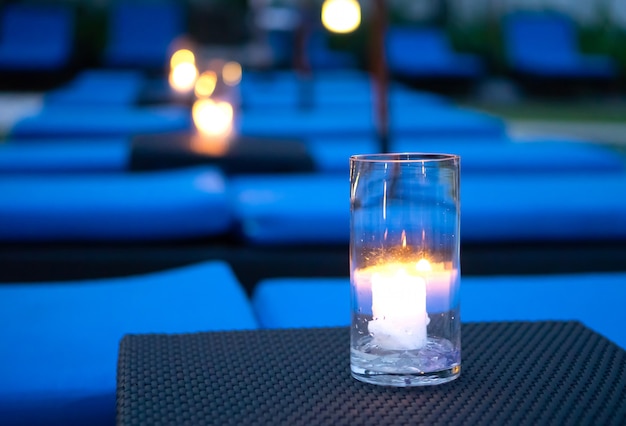 Candle light in glass on black background