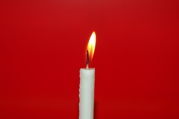 Candle light on the red color background.