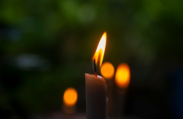 Candle light with dark bokeh background, in shallow focus