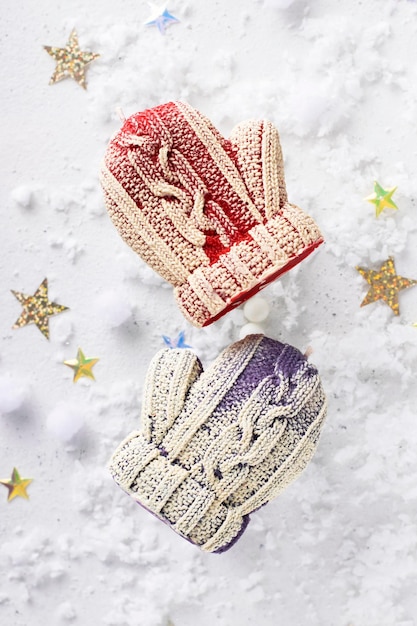 Candle mitten on a white snowy background.