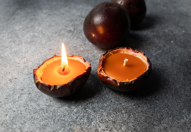 A candle in a passion fruit peel