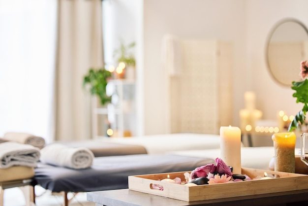 Candle spa and relax with aromatherapy treatment in a tray in a room for luxury or wellness Background health and massage with still life in an empty resort for peace skincare or relaxation