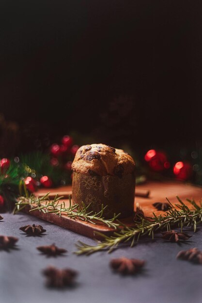 a candle that is on a table with a christmas tree in the background