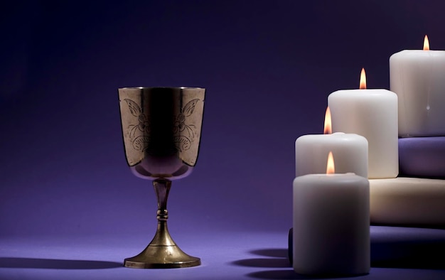 Photo a candle and a wine glass are next to a candle and a candle.