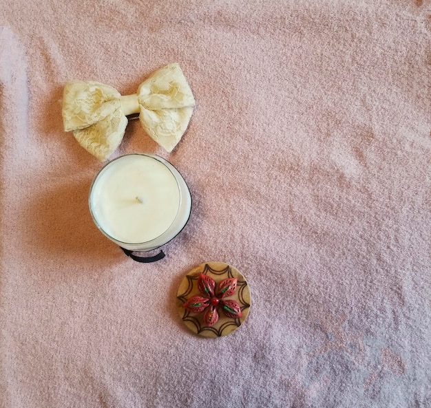 A candle with a bow on it and a candle with a candle on it