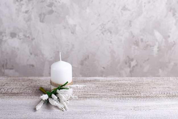 Candle with decorations on a wooden table