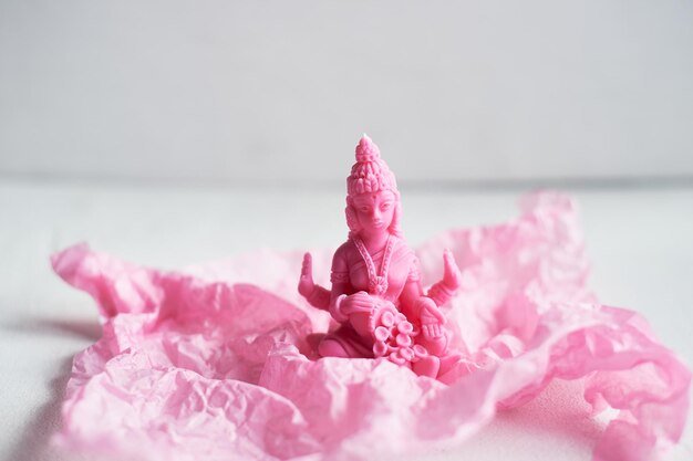 Photo the candle with the goddess lakshmi is pink femininity and fertility meditation and buddhism