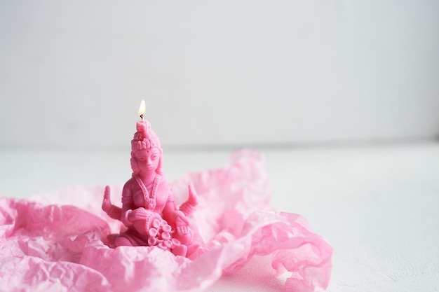 The candle with the goddess Lakshmi is pink Femininity and fertility Meditation and Buddhism