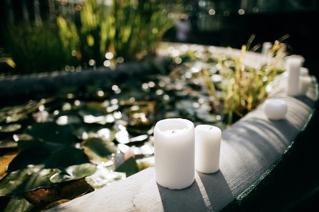 Candlelight decoration at a wedding ceremony in a summer garden near a fountain