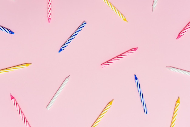 candles for a birthday cake on a pastel pink background
