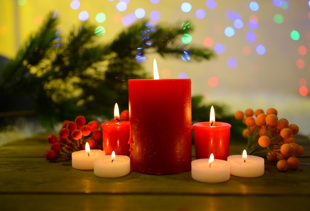 Candles and Christmas decoration on bright background