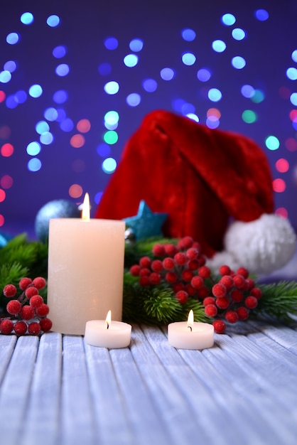 Candles and Christmas decoration on bright background