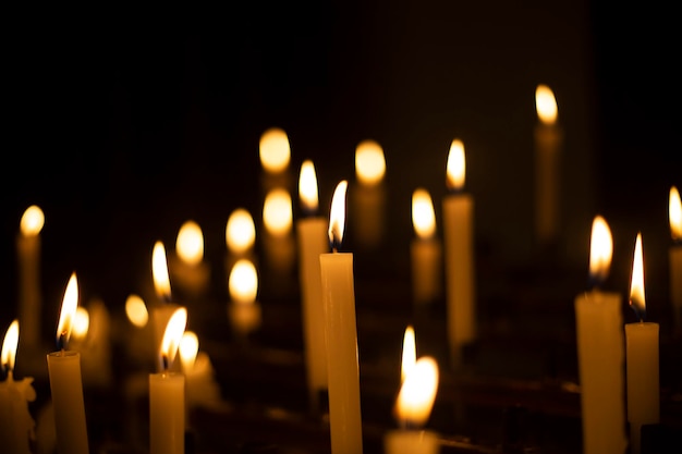 Candles lit in a dark church. Candles lit by the faithful in a church in Poland