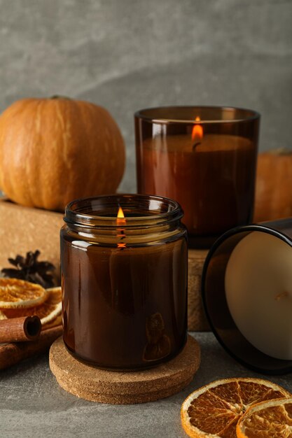 Photo candles pumpkins and oranges on gray background