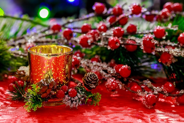 Candles and red berries decorate Christmas background