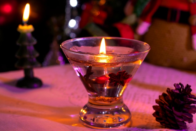 Candles on the table next to a Christmas tree, selective focus, blurred