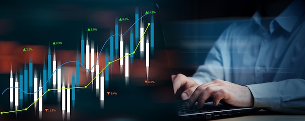 Candlestick chart man working with laptop