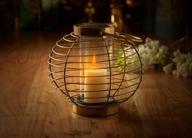 Candlestick with burning candle on a wooden table cozy interior