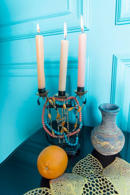 A candlestick with a jug is on the table