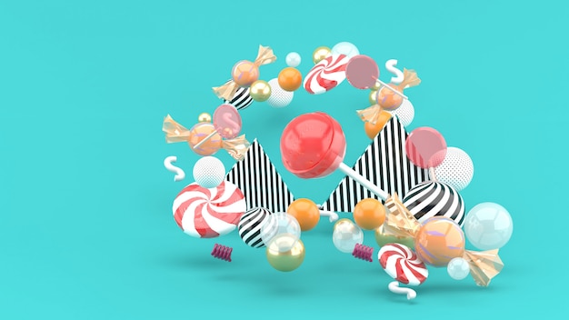 Candy among colorful balls on blue. 3d rendering.