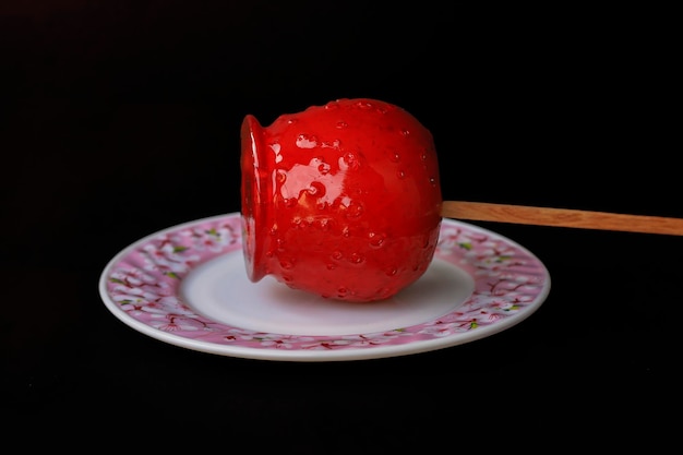 Candy apple blurred on black background